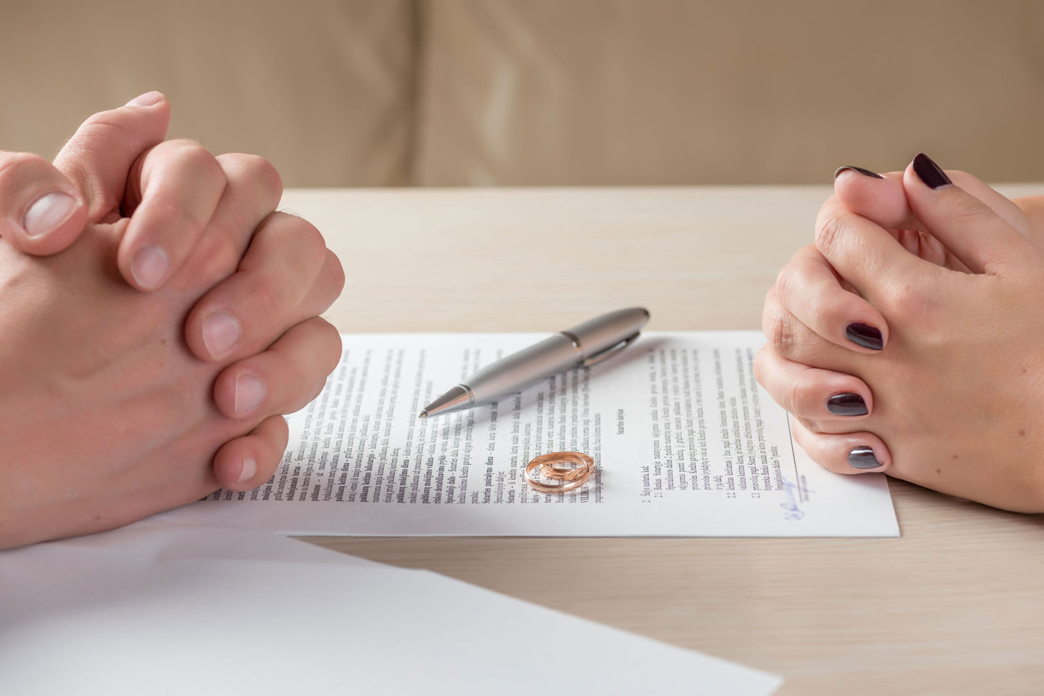 Divorce attorney sean signing papers at a lawyers office.